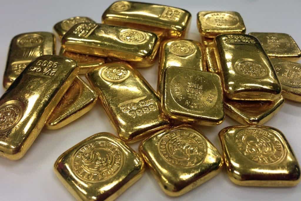 Life is a Treasure Hunt: Seek, and you will Find 1 A stack of gold bars on a white surface.
