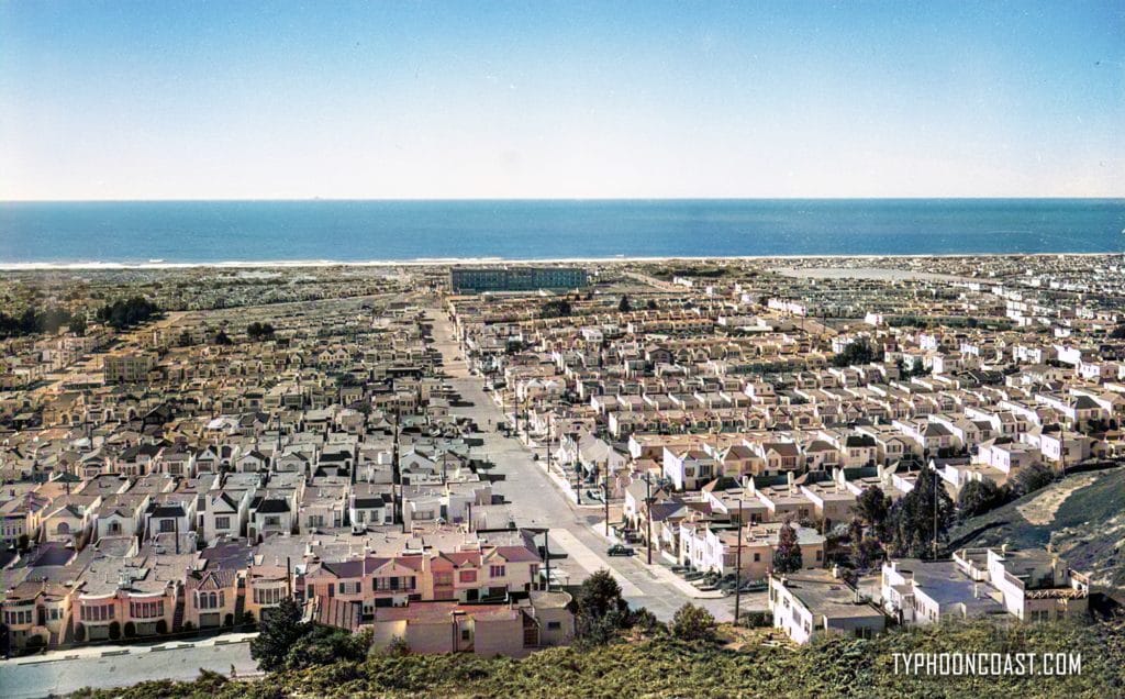 In the Outside Land: Sons of the Desert Edition 1 A fictitious city near the ocean is captured from an aerial perspective, featuring elements of history and law enforcement.